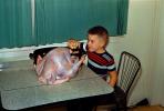 Boy Stuffs a Turkey for Thanksgiving, Table, 1950s, FDNV03P05_02