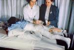 Patient in a body cast, Nurse, Baby Powder, Legs, Bed, 1949, 1940s, Spicacast, HHPV02P09_04