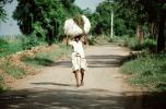 Man Walking Down a Dirt Road Carrying a Heavy Load, India, PDCV01P02_17