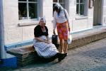 Women, native dress, hats, brick road, building, Holland, PFSV04P15_19