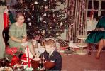 Woman, tree, decorations, poinsettia, boy, presents, 1940s, PHCV01P01_08
