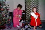 Mother and Daughter unwrapping presents, 1950s, PHCV04P15_11