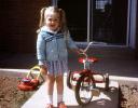 Girl, Smiles, Tricycle, Jacket, Skirt, backyard, 1960s, PLGV01P01_16