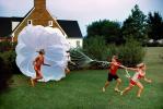 Playing with a Parachute, girl, boy, running, barefoot, lawn, 1960s, PLGV04P01_07