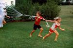 Playing with a Parachute, girl, boy, running, barefoot, lawn, 1960s, PLGV04P01_07B