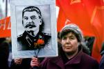 Woman holding up Stalin Poster, Pro Communism Rally, Moscow, Russia, PRSV08P08_15
