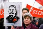 Woman holding up Stalin Poster, Pro Communism Rally, Moscow, Russia, PRSV08P08_16