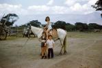 Girl on a horse, boy, smiles, 1950s, SHRV02P05_12