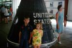 Boy and Girl stand in front of the Mercury Space Capsule, 1960s, USEV01P05_18