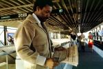 Man reading a newspaper, Daly City Station, Bay Area Rapid Transit, BART, commuters, 1980s, VRHV02P02_08